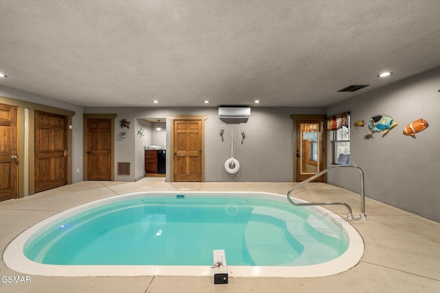 pool with a jacuzzi and an AC wall unit