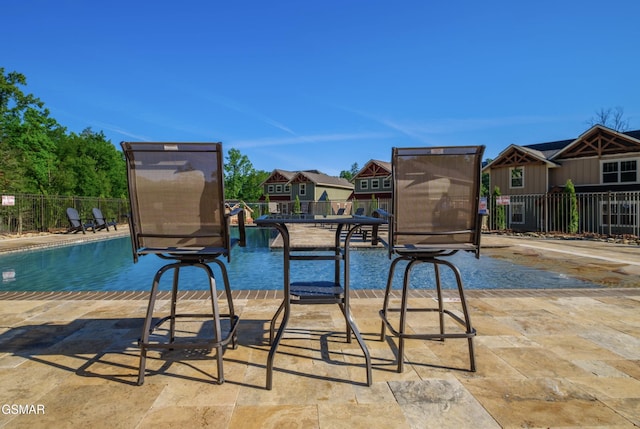 community pool with a residential view and fence