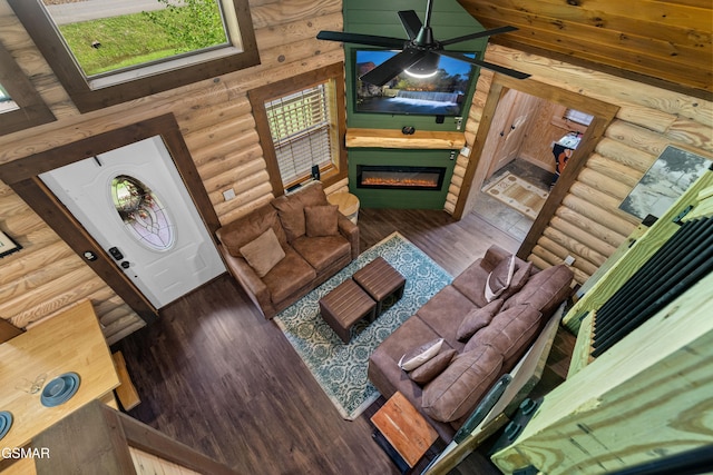 3040 Grassy Branch Loop, Sevierville, TN 37876 - living room with ceiling fan, log walls, a glass covered fireplace, and wood finished floors
