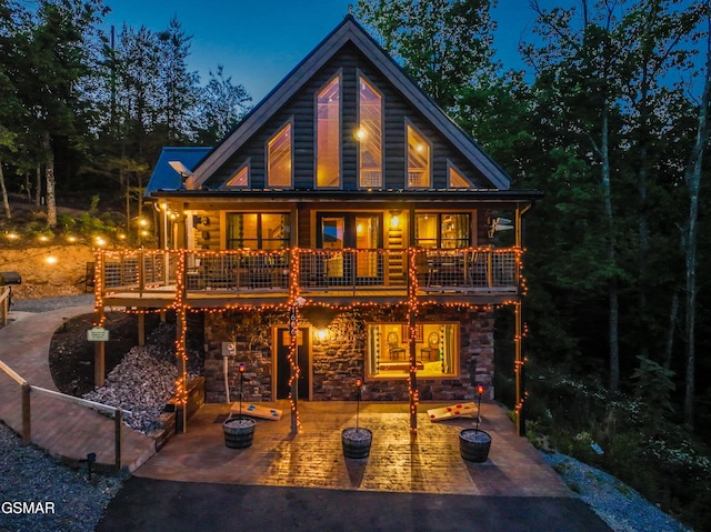 rear view of house featuring a deck and a patio