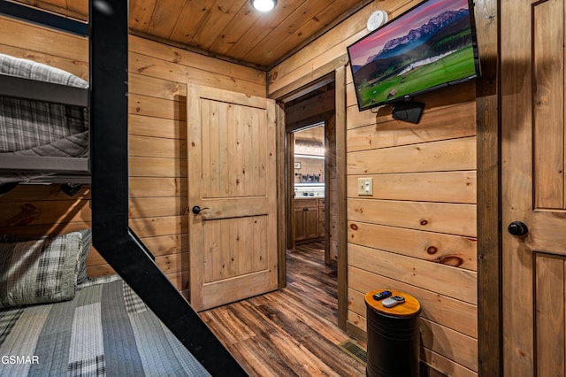 interior space with wood ceiling, hardwood / wood-style flooring, and wooden walls