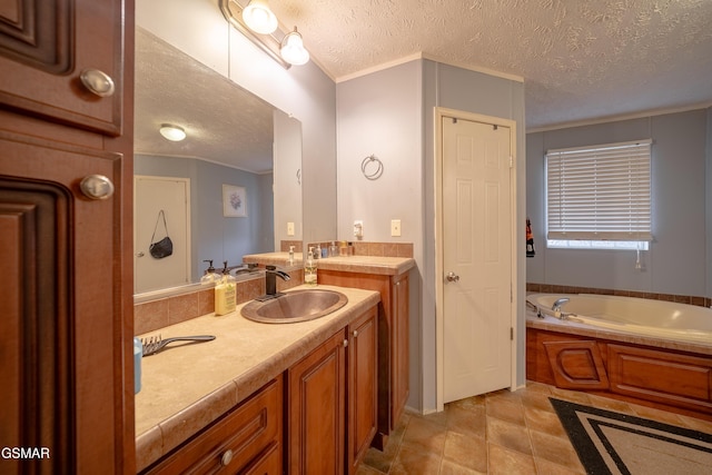 bathroom with crown molding, tile patterned flooring, vanity, a textured ceiling, and a bathing tub