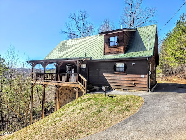 chalet / cabin featuring metal roof