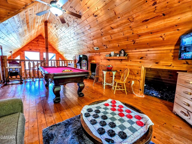 recreation room featuring hardwood / wood-style floors, wooden walls, wooden ceiling, ceiling fan, and vaulted ceiling