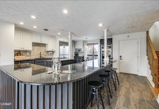 1130 Ski View Dr Unit 315, Gatlinburg, TN 37738 - kitchen with appliances with stainless steel finishes, tasteful backsplash, stone tile flooring, recessed lighting, and white cabinetry