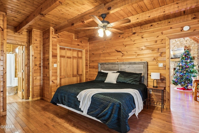 bedroom with hardwood / wood-style flooring, wood ceiling, and wooden walls