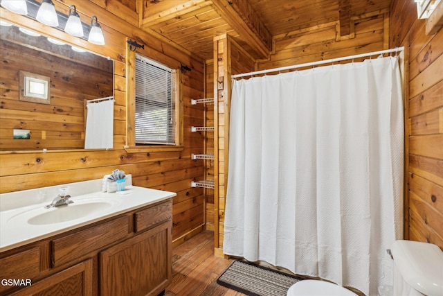 full bathroom featuring curtained shower, toilet, wood walls, vanity, and wooden ceiling