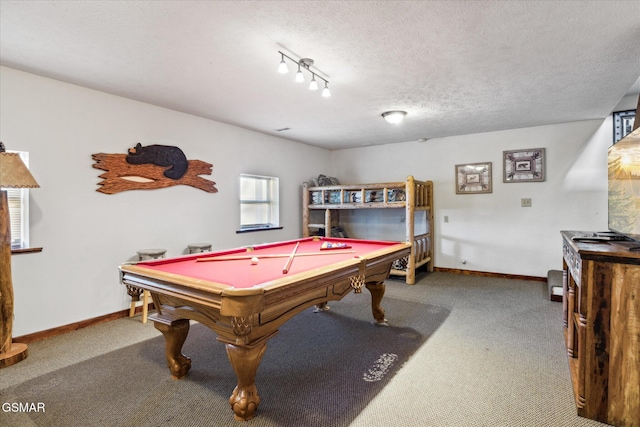 playroom with a textured ceiling, carpet, and baseboards