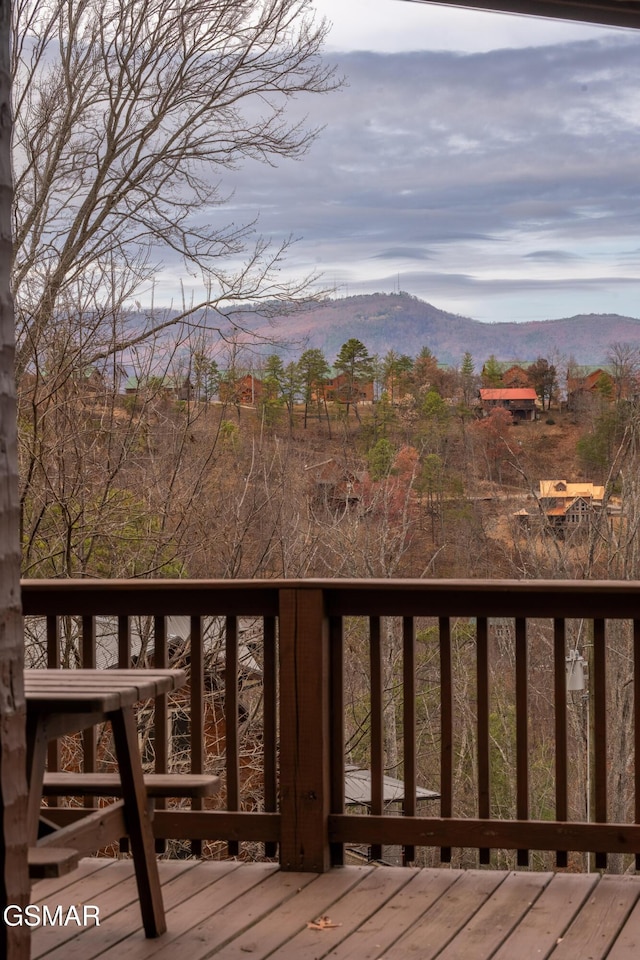 wooden deck with a mountain view