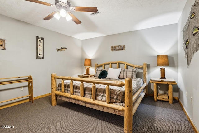 carpeted bedroom with baseboards, visible vents, ceiling fan, and a textured ceiling