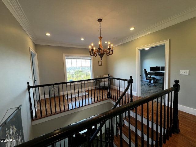 hallway featuring an inviting chandelier, crown molding, dark wood-style flooring, and an upstairs landing