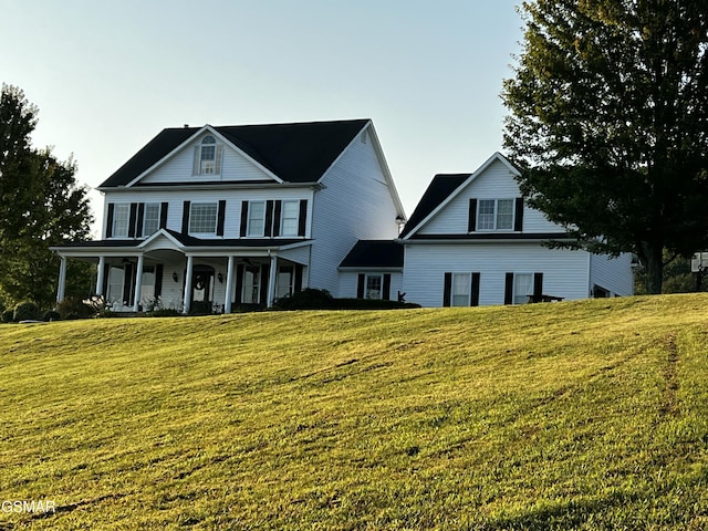 view of front of house featuring a porch and a front lawn