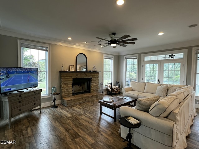 living area with crown molding, a fireplace, ceiling fan, and dark wood-type flooring