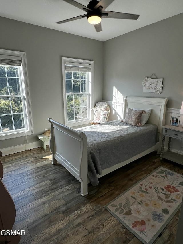 bedroom with ceiling fan and dark wood-type flooring