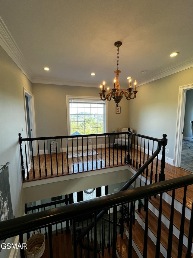 stairway with ornamental molding, a chandelier, wood finished floors, and recessed lighting