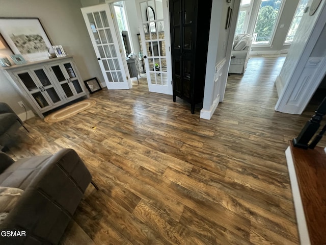 interior space featuring dark wood-style floors, french doors, and baseboards