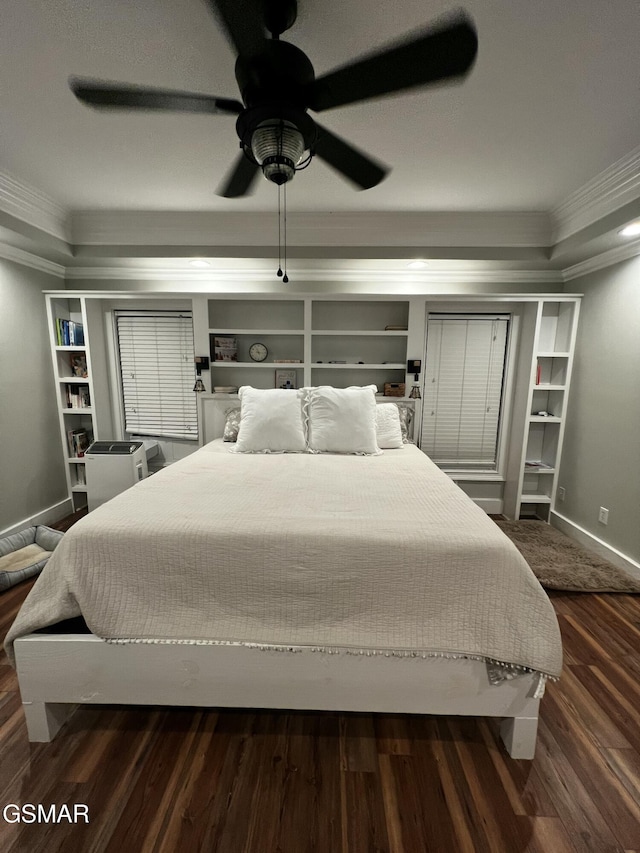 bedroom featuring dark wood-type flooring, crown molding, baseboards, and ceiling fan