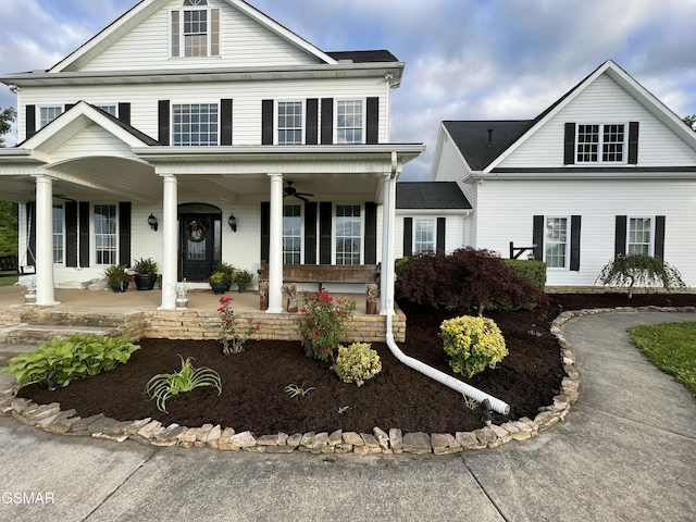 neoclassical home with a porch and ceiling fan