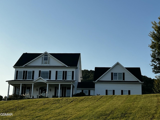 view of front of home featuring covered porch and a front yard