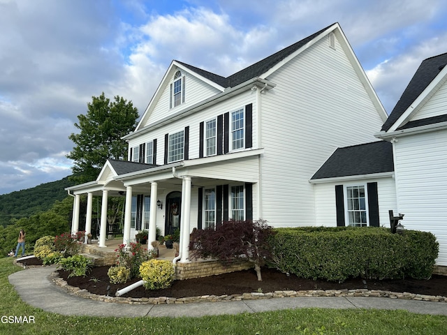 view of front of home featuring a porch and roof with shingles