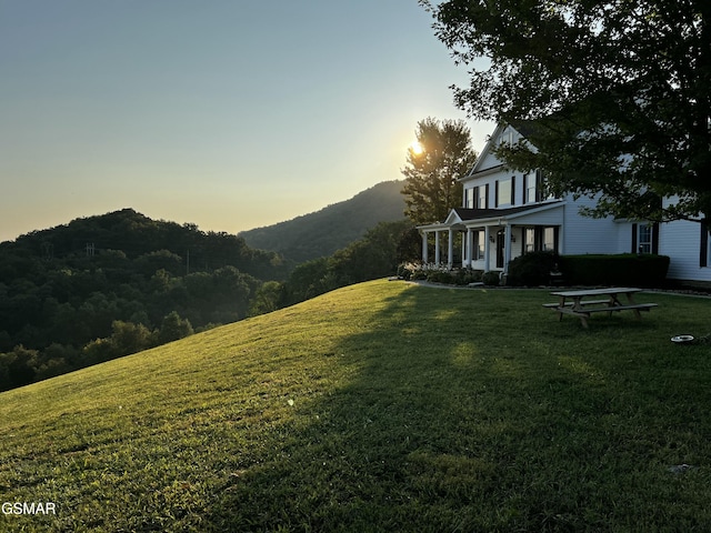 view of yard featuring a porch and a mountain view