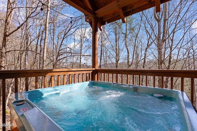 wooden deck featuring a hot tub