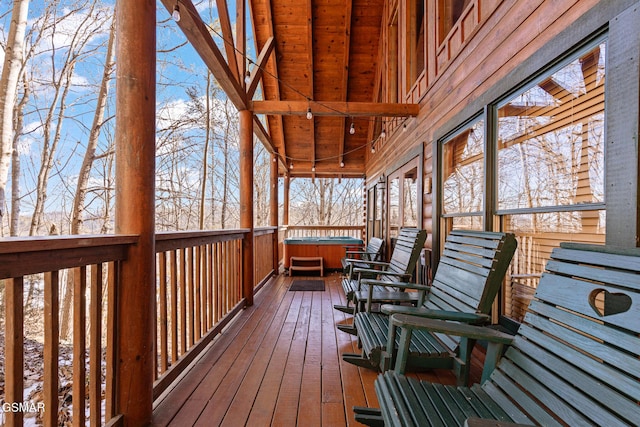 snow covered deck featuring a hot tub