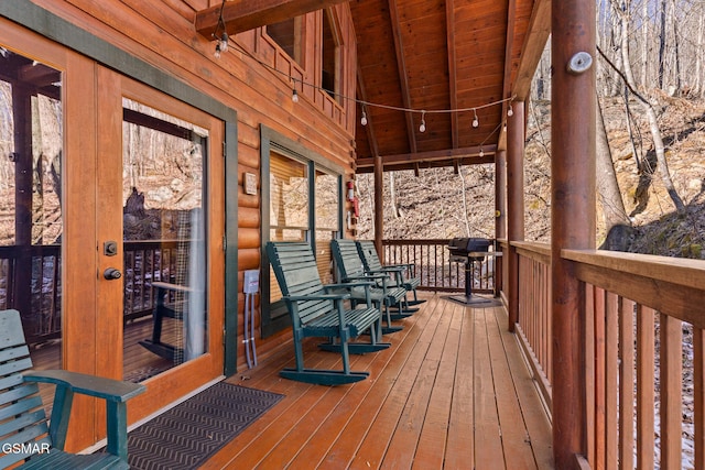 wooden deck featuring french doors and a grill