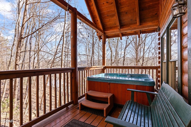 wooden terrace with a hot tub