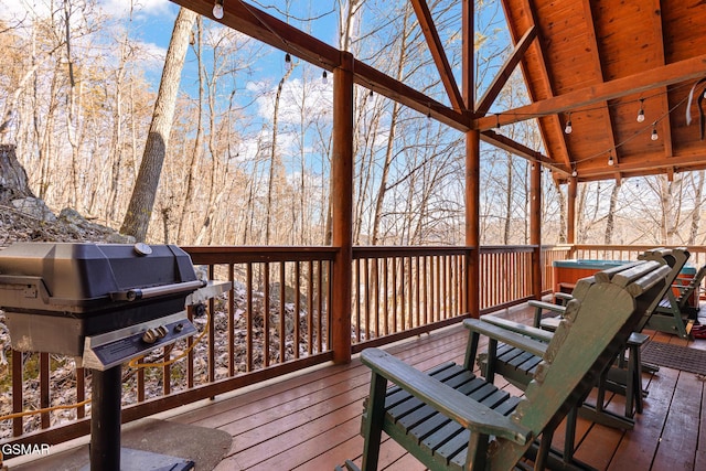 wooden deck featuring a hot tub