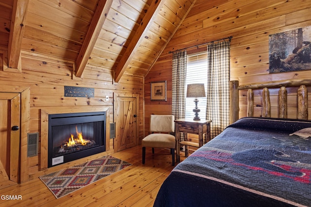 bedroom featuring vaulted ceiling with beams, wood-type flooring, wooden ceiling, and wooden walls