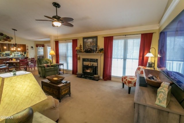 carpeted living room with a ceiling fan, lofted ceiling, crown molding, and a premium fireplace