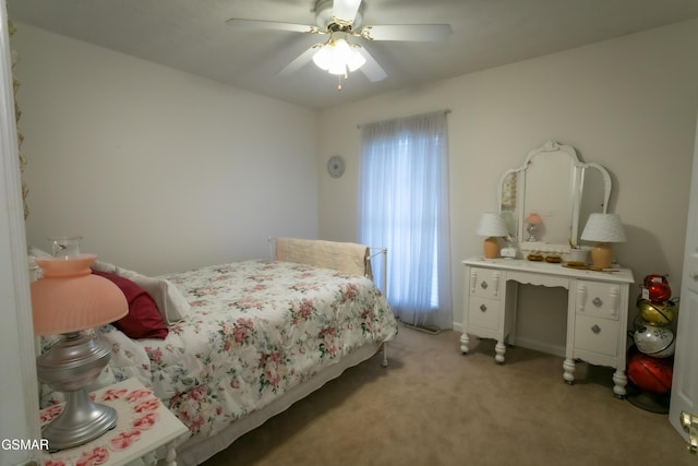 bedroom featuring a ceiling fan and light colored carpet