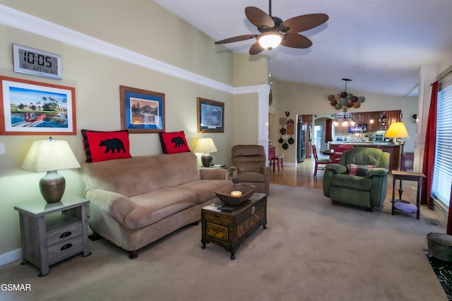 living area with lofted ceiling, ceiling fan with notable chandelier, and light colored carpet