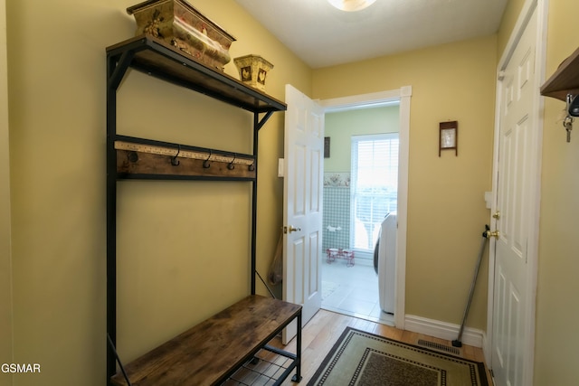 mudroom with light wood-style flooring and baseboards