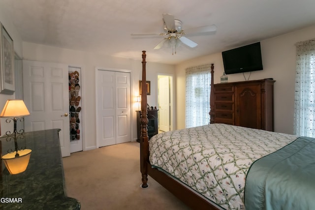 bedroom with a ceiling fan and light colored carpet