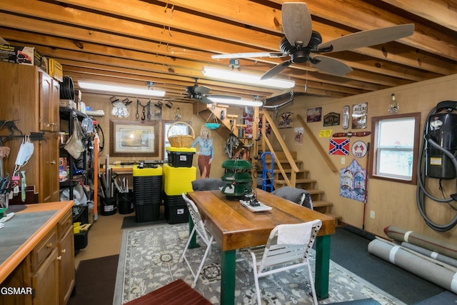 basement featuring a ceiling fan and stairs