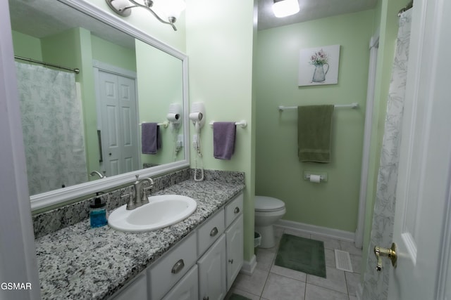 bathroom featuring baseboards, visible vents, toilet, tile patterned floors, and vanity