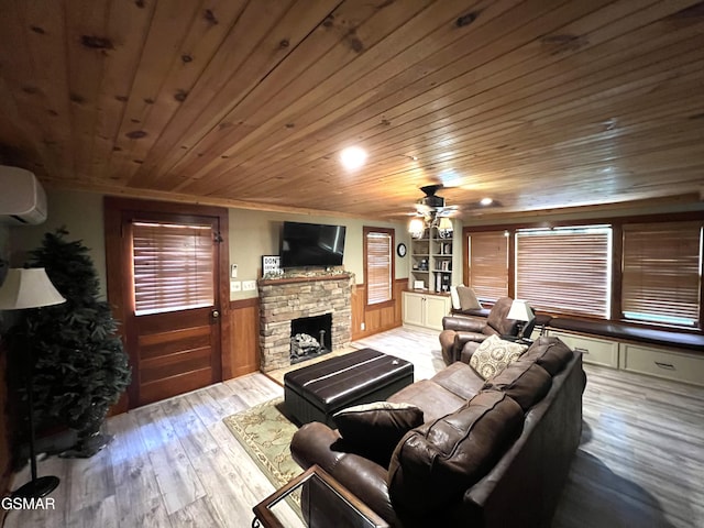 222 Poplar Ln, Gatlinburg, TN 37738 - living area with a stone fireplace, a wainscoted wall, a wall unit AC, wood finished floors, and wooden ceiling