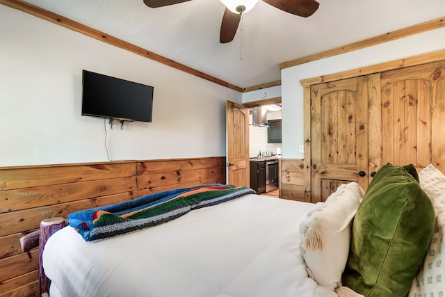 bedroom featuring crown molding, wainscoting, ceiling fan, and wooden walls