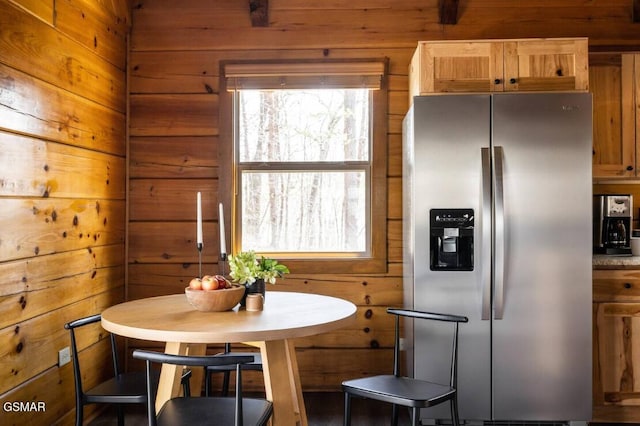 dining space with wood walls and plenty of natural light