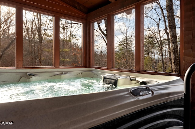 unfurnished sunroom featuring a jacuzzi