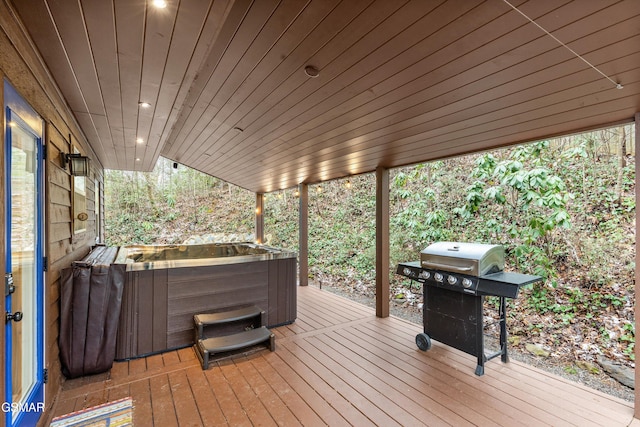 wooden deck featuring a hot tub and grilling area