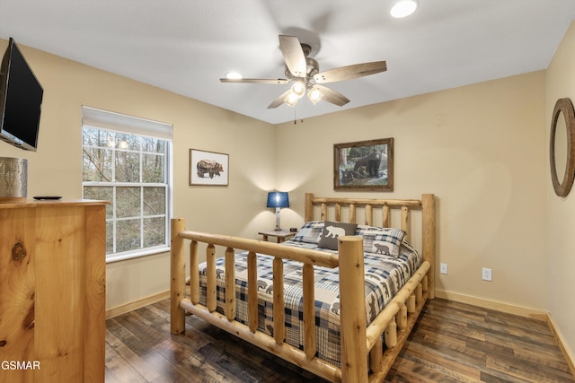 bedroom with wood finished floors and baseboards