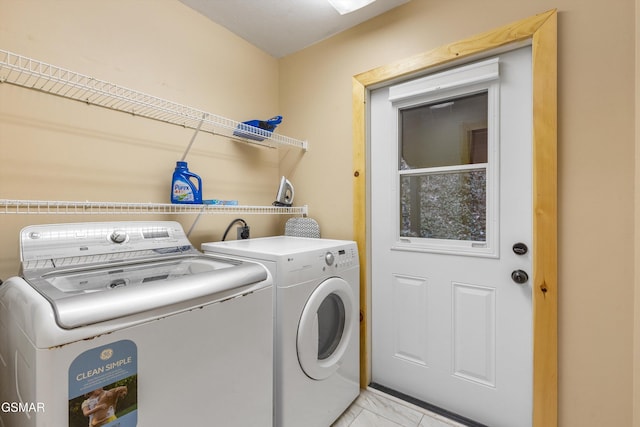 laundry area with marble finish floor, laundry area, and washing machine and clothes dryer