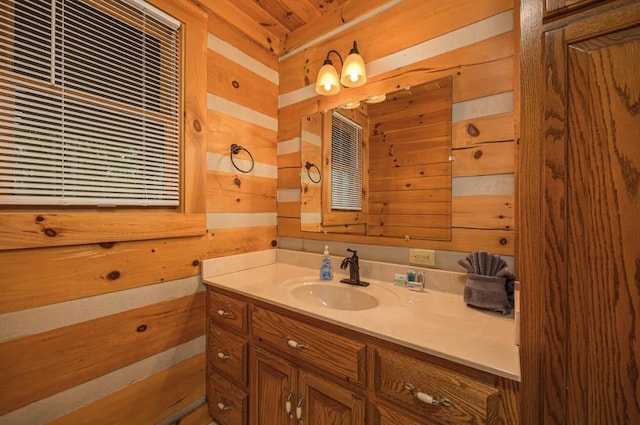 bathroom featuring vanity and wood walls