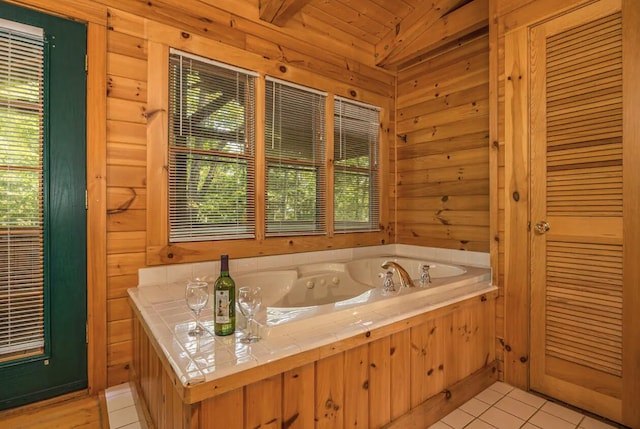 bathroom featuring tile patterned floors, a washtub, lofted ceiling, and log walls