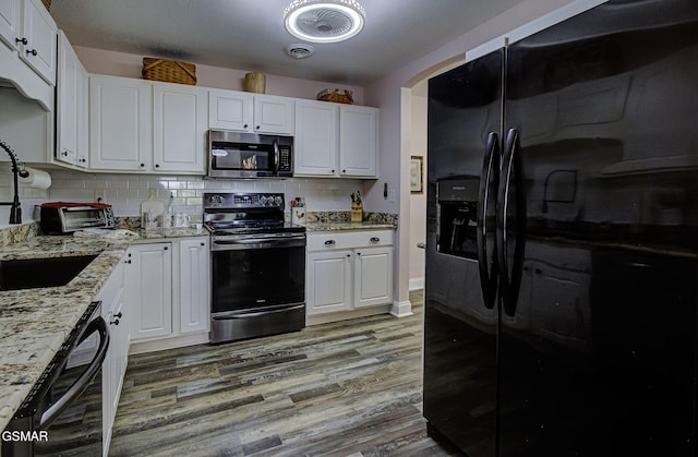 220 River Garden Ct Unit 38, Sevierville, TN 37862 - kitchen with black fridge with ice dispenser, electric range oven, stainless steel microwave, white cabinetry, and dishwasher