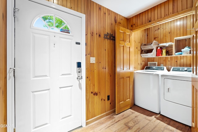 2295 Bluff Mountain Rd, Sevierville, TN 37876 - washroom with washer and dryer, light wood-style floors, and wooden walls