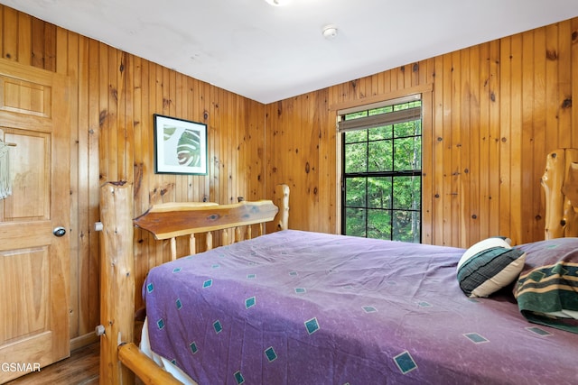 2295 Bluff Mountain Rd, Sevierville, TN 37876 - bedroom featuring wood walls and wood finished floors